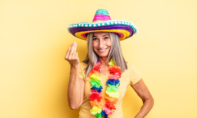 middle age pretty woman making capice or money gesture, telling you to pay. mexican party concept