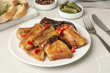 Tasty fried pork lard with pepper on light table