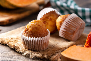 Pumpkin muffins on wooden table	