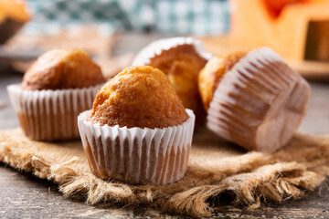 Pumpkin muffins on wooden table	