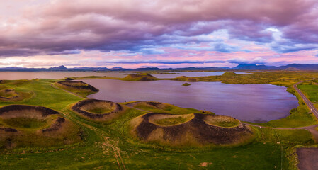 Aerial panoramic view of Myvatn, Iceland at epic sunset. Volcanic Craters In Green Plaints and link clouds and sky