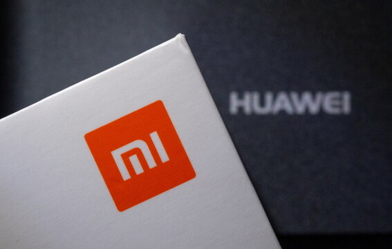 Xiaomi and Huawei logos are seen on smartphone boxes in this illustration
