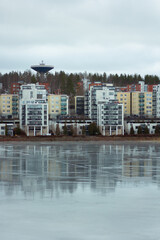 modern residential houses by the frozen lake in winter 