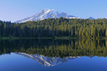 Mount Rainier mirroring in lake, National Park, popular touristic and hiking destination in Washington, United States