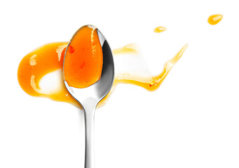 Chili sauce in spoon isolated on white background. Close up, top view.