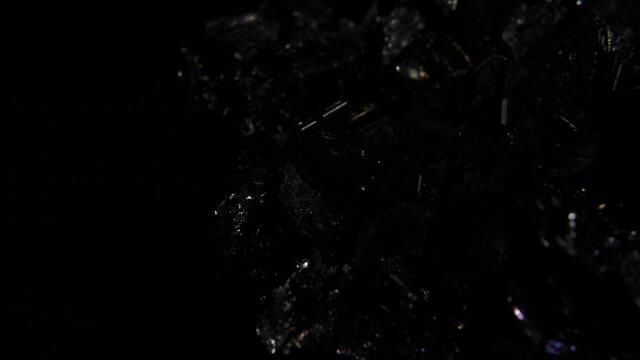 Beautiful black rock with shine effect, light movement and reflections.