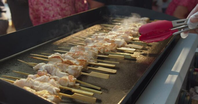 Cook Grilling Chicken Skewers On Electric Griller For Wedding Guests. - close up 4k