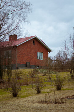 red brick house in the countryside in spring 