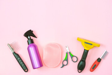pet care and grooming tools on a pink background.