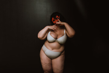 Curvy woman wearing demon mask. Fine art concept