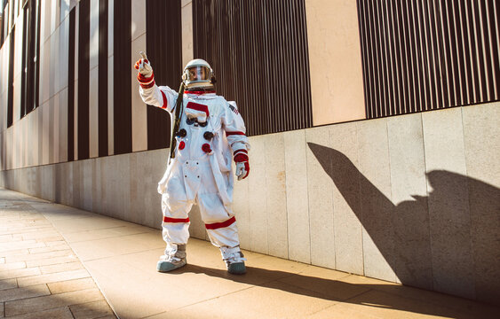 spaceman in a futuristic station. Man with space suit walking in an urban area