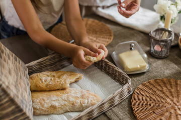 Girl breaking freshly baked ciabatta at home