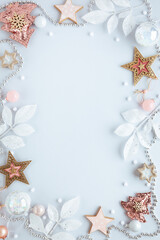 Christmas and New Year holidays frame. Christmas ornaments on light pastel background. Flat lay, copy space.