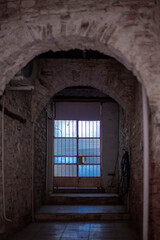 Fototapeta na wymiar glass door at the end of stone passage