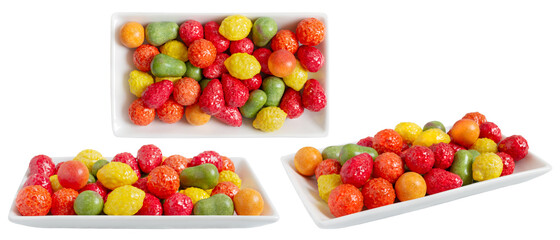 Chewing colorful gum in the form of fruit on a plate isolated on white background. Different viewing angles.