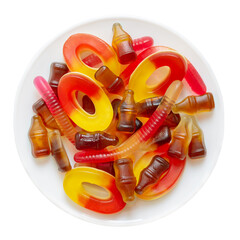 Chewy candy in the form of cola, worms, loopies on the plate isolated on white background. Top view.