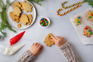 Child decorates Christmas gingerbread