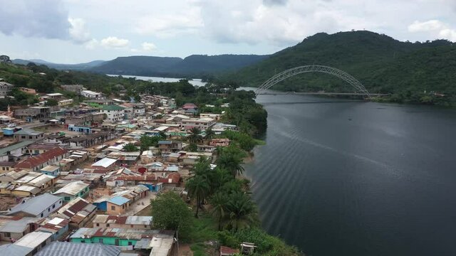 Aerial Adome bridge village homes Volta river Ghana part. Main river system in West African country of Ghana. Akosombo dam generating hydroelectricity. Largest man made reservoir by area in the world.