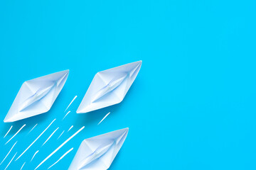 Paper boat on blue background