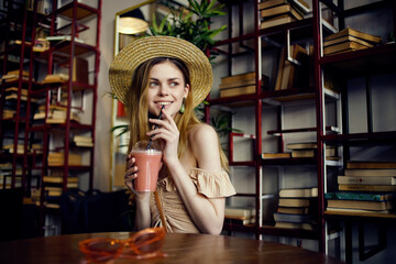 cheerful woman sitting at a table with a drink in a cafe recreation
