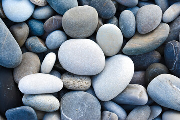 Fototapeta na wymiar Pebbles close-up. Beach with pebbles. Background with pebbles - round sea stones. Top view.