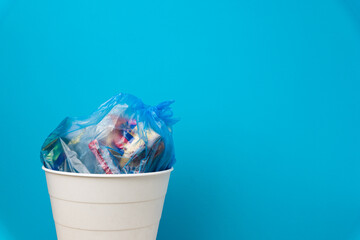 White crumpled paper beacons are thrown in the trash can.
