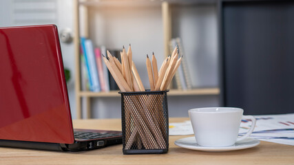 Business computer office desk with desktop laptop, tablet, budget, tax, calculator, and annual, summary report place on wooden table, working space at home. Business executive office table concept. © prachid