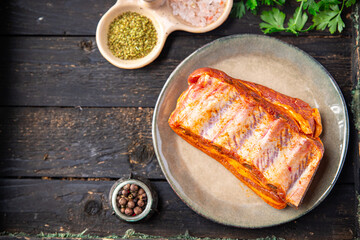 raw ribs pork meat pickled spices and herbs fresh portion ready to eat meal snack on the table copy space food background rustic. top view keto or paleo diet