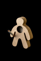 Cardboard man holding a cigarette on his hand. Addiction