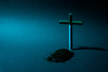 Fototapeta premium Cross from a cigarette against a dark background. Symbol