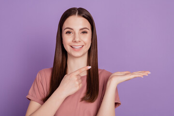 Photo of pretty lady point finger product open hand offer isolated on purple background