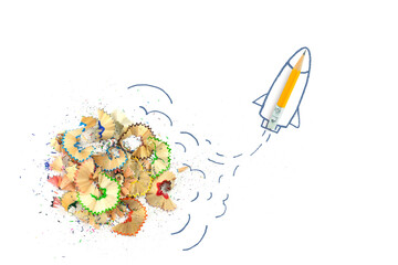 Pencil, shavings from pencils with rocket drawn on white background