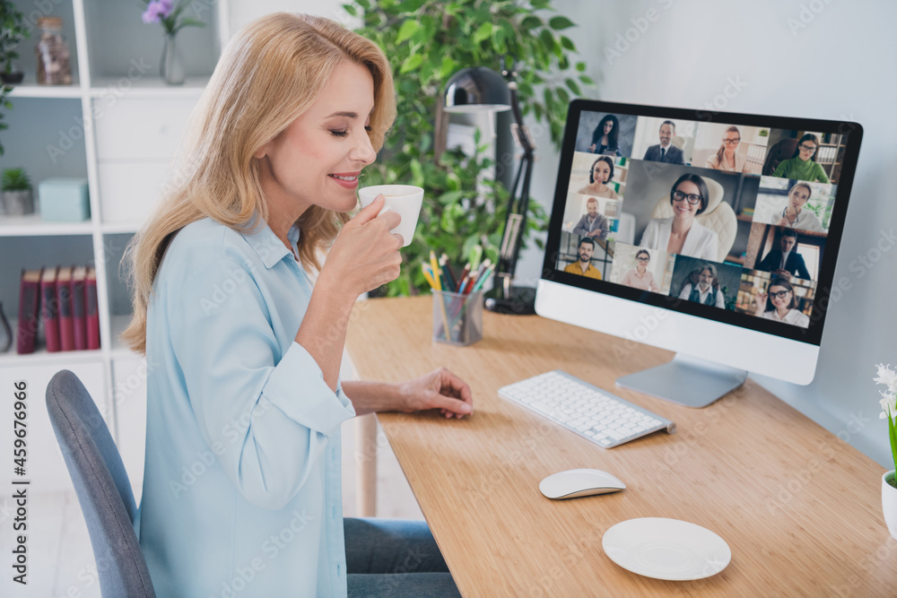 Sticker Photo of shiny sweet woman dressed blue shirt sitting table having video conference modern gadget drinking coffee indoors home room