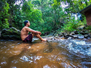 man in silence in natural waterfall at green forests from different angle
