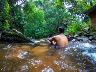 man in silence in natural waterfall at green forests from different angle