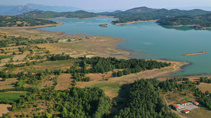 Aerial drone top down photo of beautiful artificial lake of Plastiras or Tavropos with wonderful nature and famous outdoor and water activities like canoe and water bike, Thessaly, Greece 