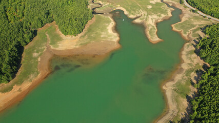 Aerial drone top down photo of beautiful artificial lake of Plastiras or Tavropos with wonderful nature and famous outdoor and water activities like canoe and water bike, Thessaly, Greece 