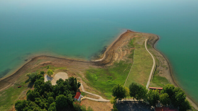 Aerial drone top down photo of beautiful artificial lake of Plastiras or Tavropos with wonderful nature and famous outdoor and water activities like canoe and water bike, Thessaly, Greece 