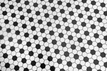 Texture of a mosaic floor made of hexagonal tiles in black
