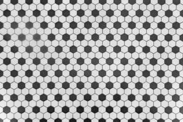 Texture of a mosaic floor made of hexagonal tiles in black