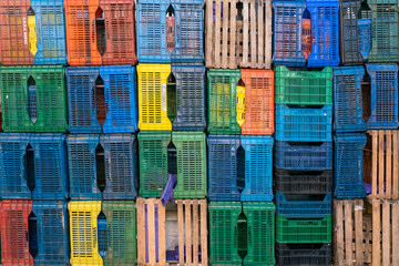 Texture of multi-colored plastic containers in a warehouse.