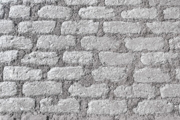 Texture of even masonry fence or horizontal surface.