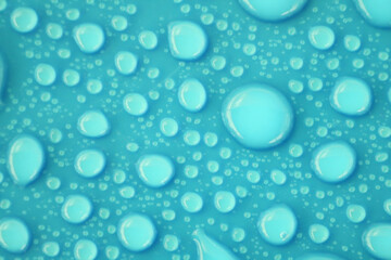 Blurred water drops on blue background texture