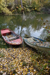 Colourful boats tied up at the shore of Blaue Adria recreational area and natural habitat on an autumn day, Altrip Germany