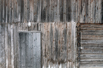 Texture of rain-darkened planks - wall of a wooden barn.