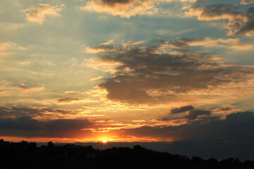 Picturesque view of beautiful cloudy sky with setting sun