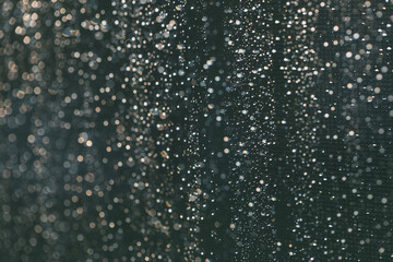Naklejka na ściany i meble Rain drops background in dark time of day