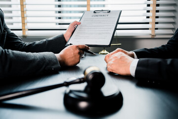Close up of businessmen or lawyers discussing contract or business agreement at law firm office,...