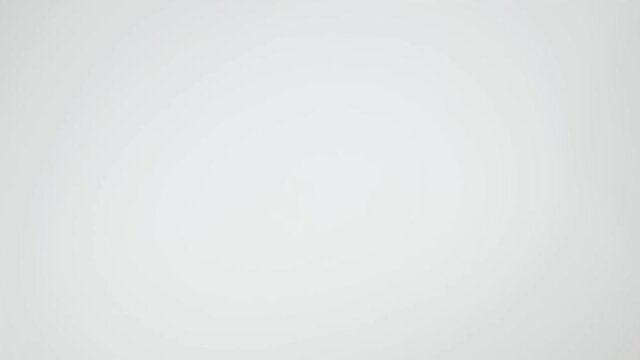 The coffee beans spin rotate quickly fast fly, dispart, splash to the sides with centrifugal coriolis force. The video is in reverse. Coffee beans twist, create pattern, make design shape picture.