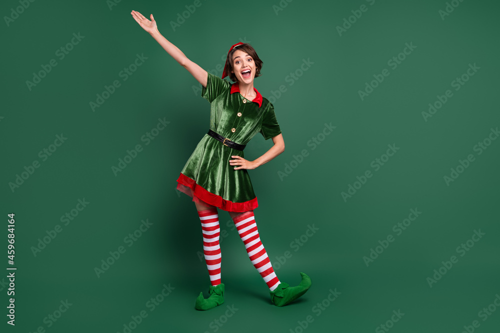 Sticker Full length body size view of attractive cheerful funny girl elf having fun celebratory isolated over green color background